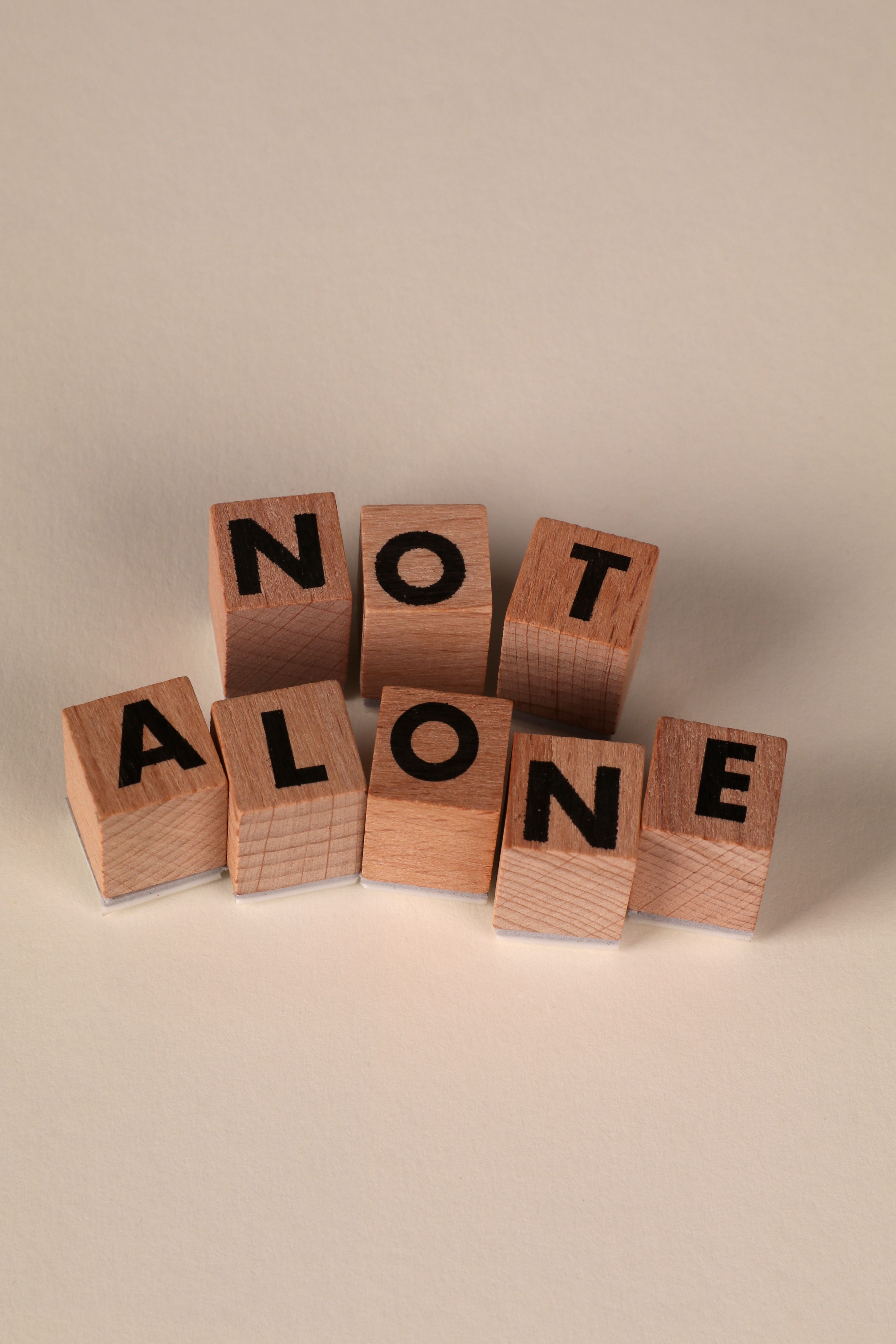 Wooden Blocks Displaying 'Not Alone' Message · Free Stock Photo