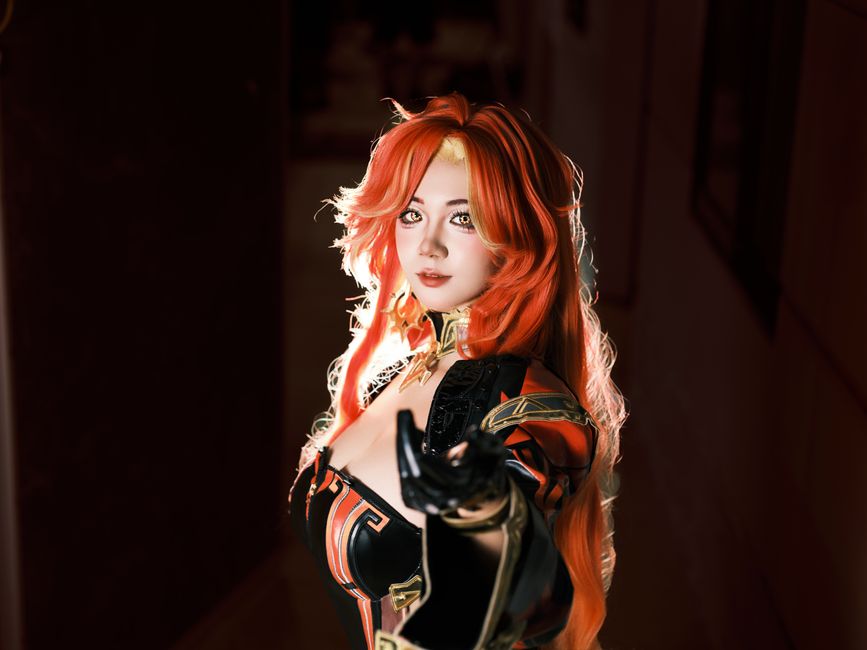 Striking cosplay portrait featuring a red-haired character in dynamic lighting. Perfect for fantasy themed projects.