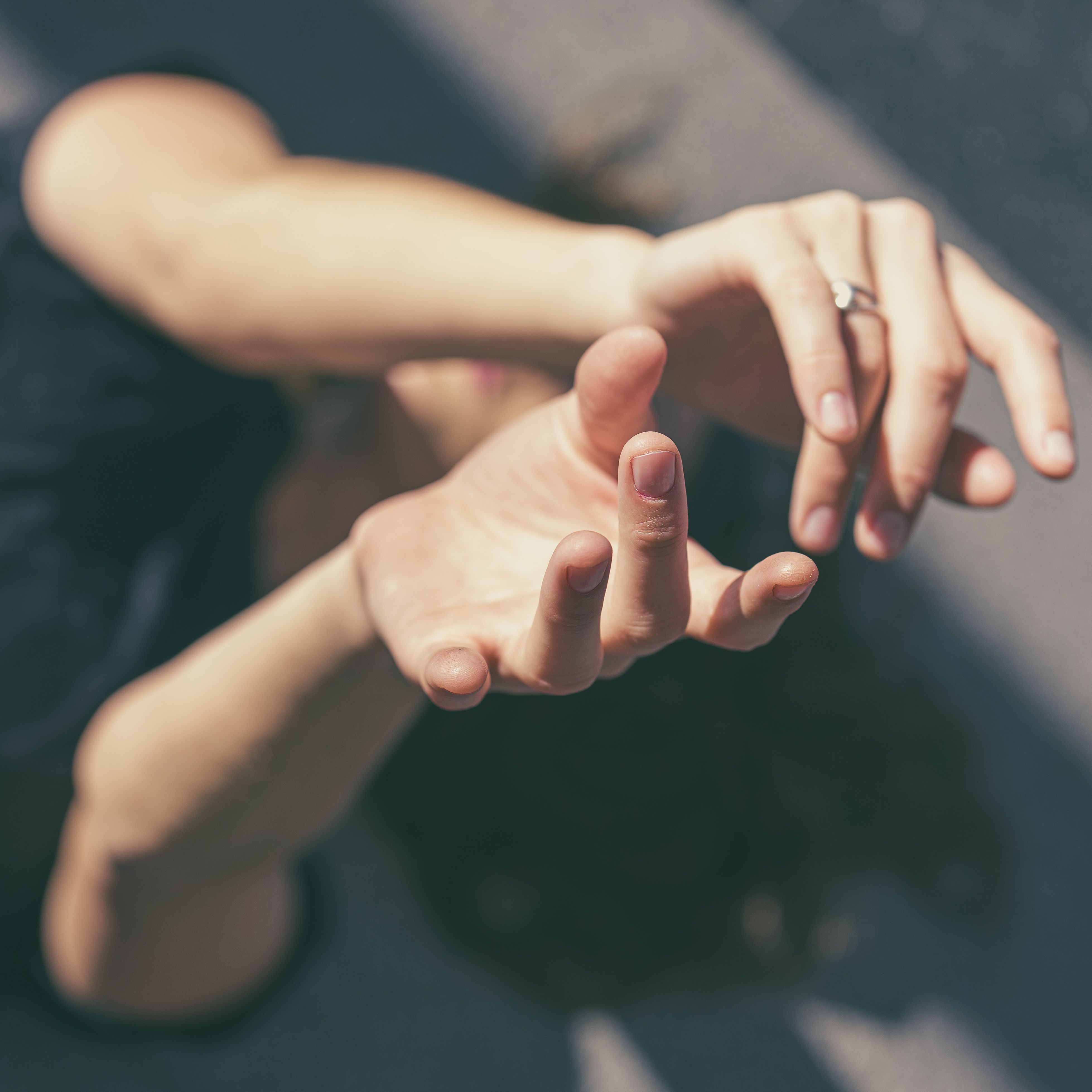 A unique artistic photo capturing hands reaching towards the sky in Buenos Aires, Argentina.