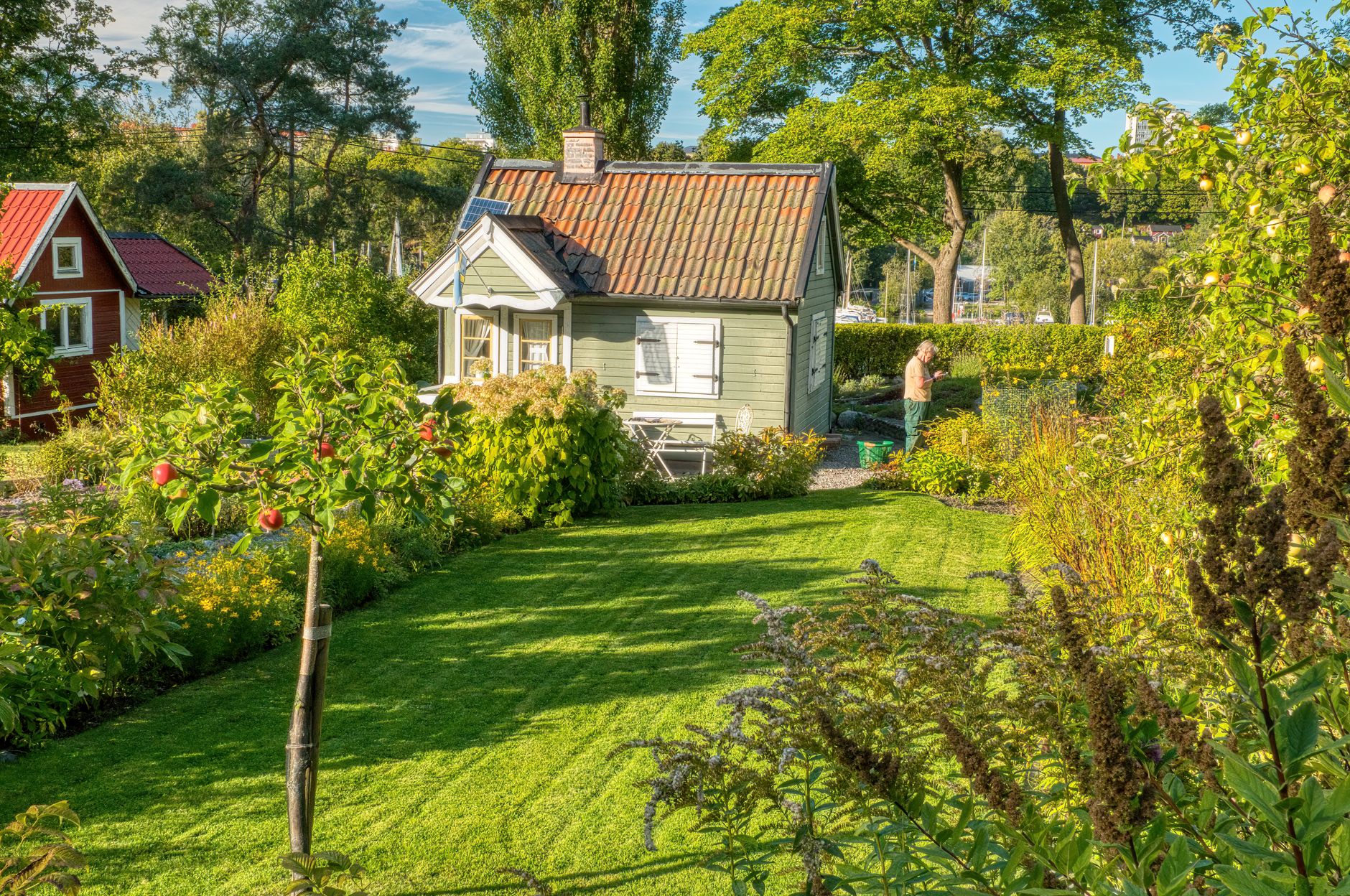 A picturesque summer garden with a quaint cottage in Stockholm, Sweden.