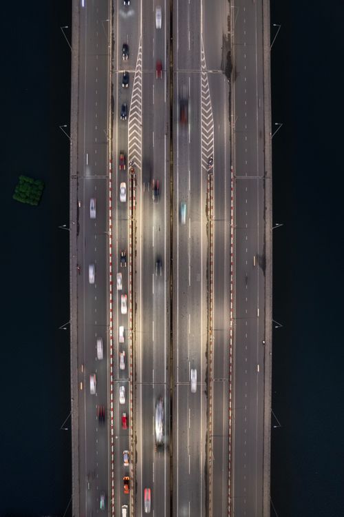 Free Highway bridge with flowing traffic and blurred lights viewed from above at night. Stock Photo