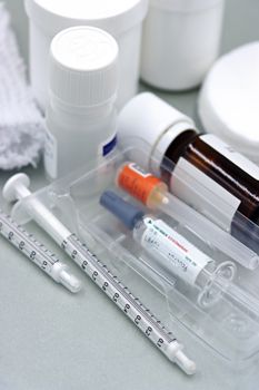 Detailed image of syringes and vaccine vials, illustrating immunization tools.