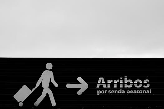 Black and white photo of an airport arrivals sign in Buenos Aires, Argentina.