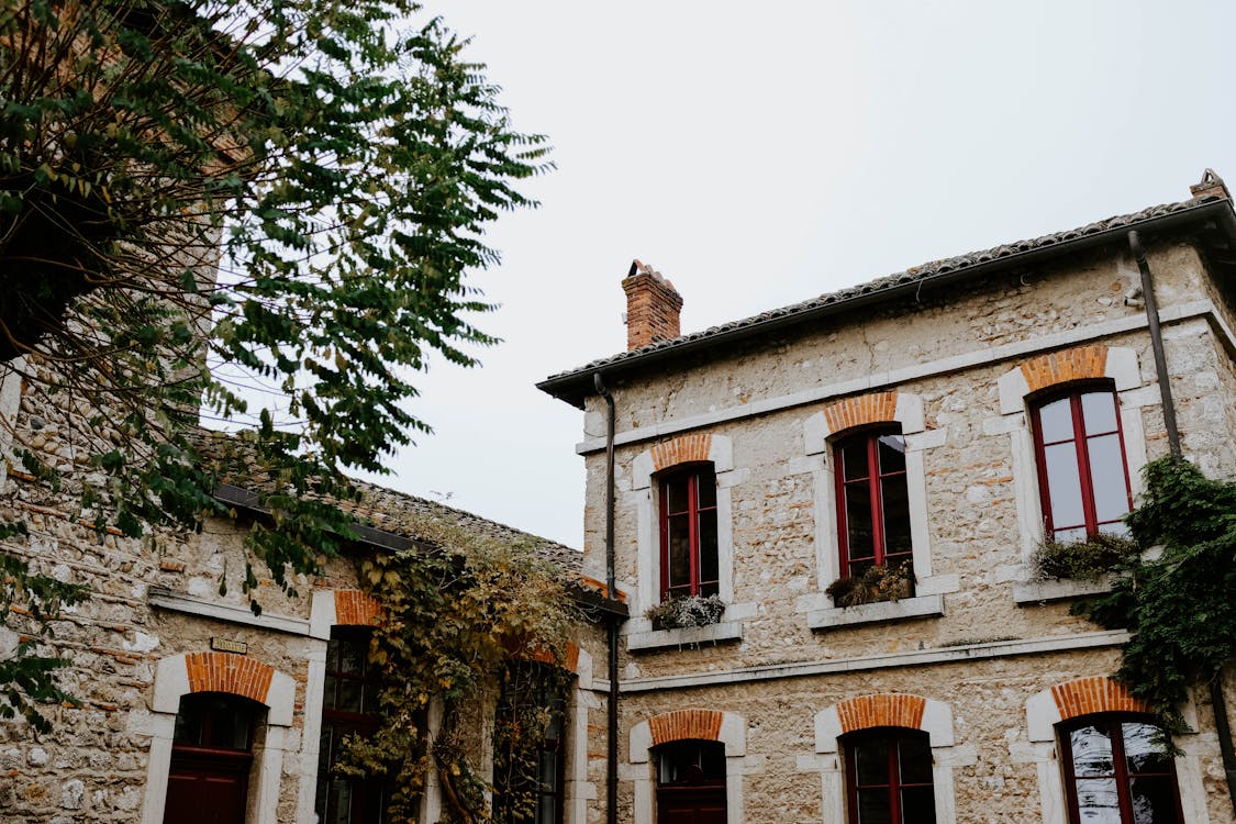 An old house with multiple windows and a chimney