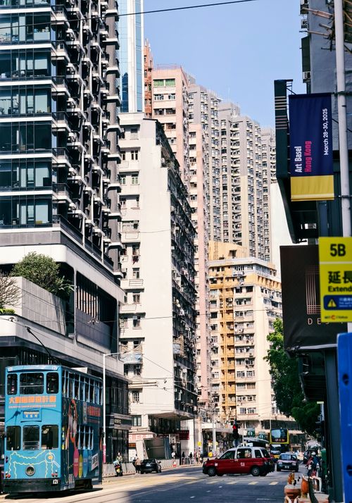 Free Vibrant urban scene in Hong Kong showcasing bustling streets, trams, and towering skyscrapers. Stock Photo