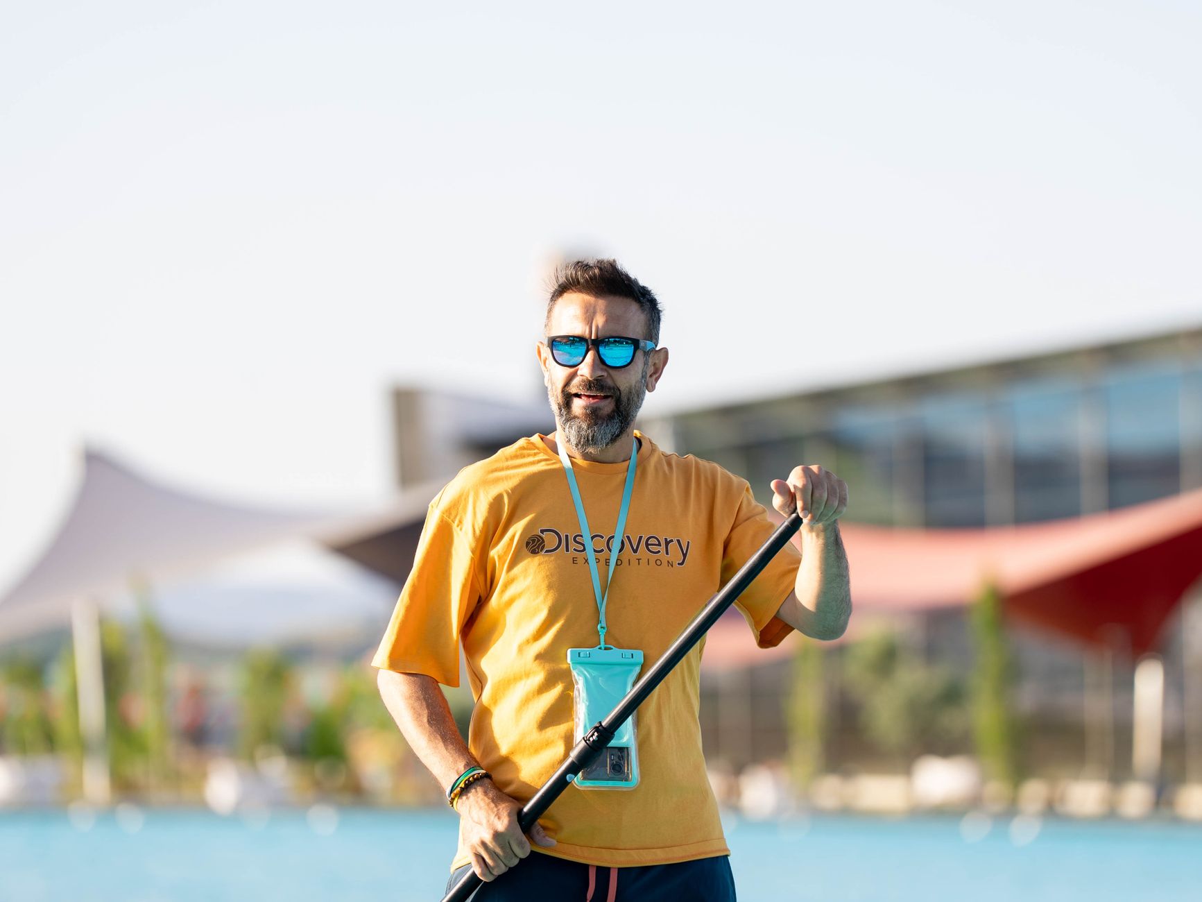 Adult male paddleboarding outdoors at a pool in sunny Kahramanmaraş, Türkiye.