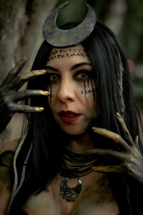 Free A mysterious woman with gothic makeup and moon headdress, evoking fantasy and mysticism. Stock Photo