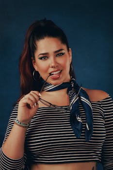 Portrait of a fashionable woman in Cyprus, posing with sunglasses and striped attire.