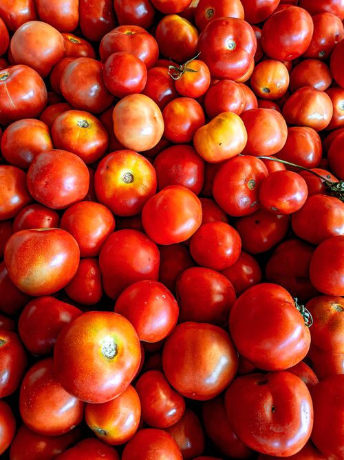 Free A vibrant image of fresh red tomatoes piled in abundance, showcasing their ripe and juicy texture. Stock Photo