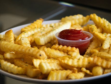 Close-up of delicious crinkle-cut fries with a side of ketchup, perfect food photography.