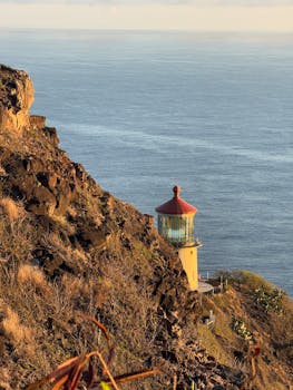 Stunning view of Makapu'u Lighthouse perched on rocky cliff with Pacific Ocean in the background.