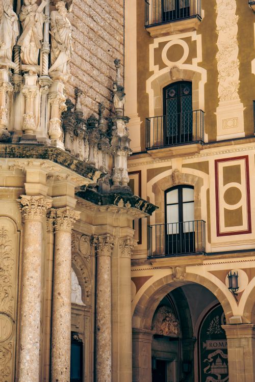 Free Elegant architectural details of Montserrat Monastery in Catalonia, Spain, showcasing intricate stone carvings. Stock Photo