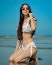 Woman in White Bikini Posing on a Sunny Beach