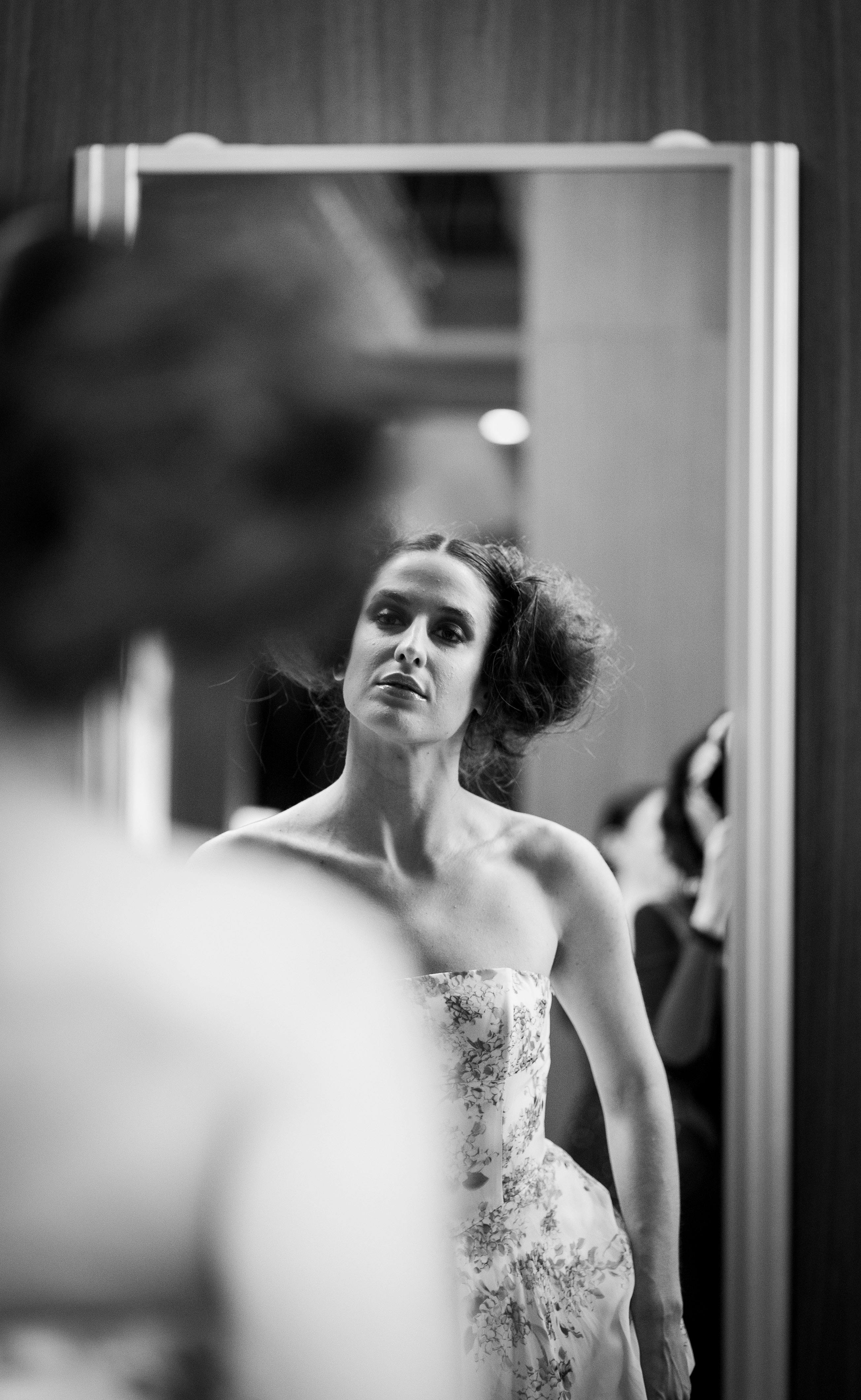 Black and white portrait of a woman in a mirror, capturing elegance and reflection in Milan.