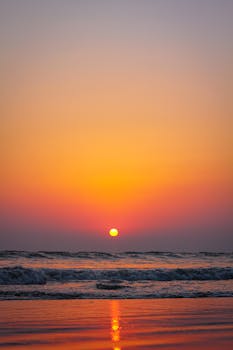 Stunning sunset over ocean waves with vibrant colors and peaceful ambiance.
