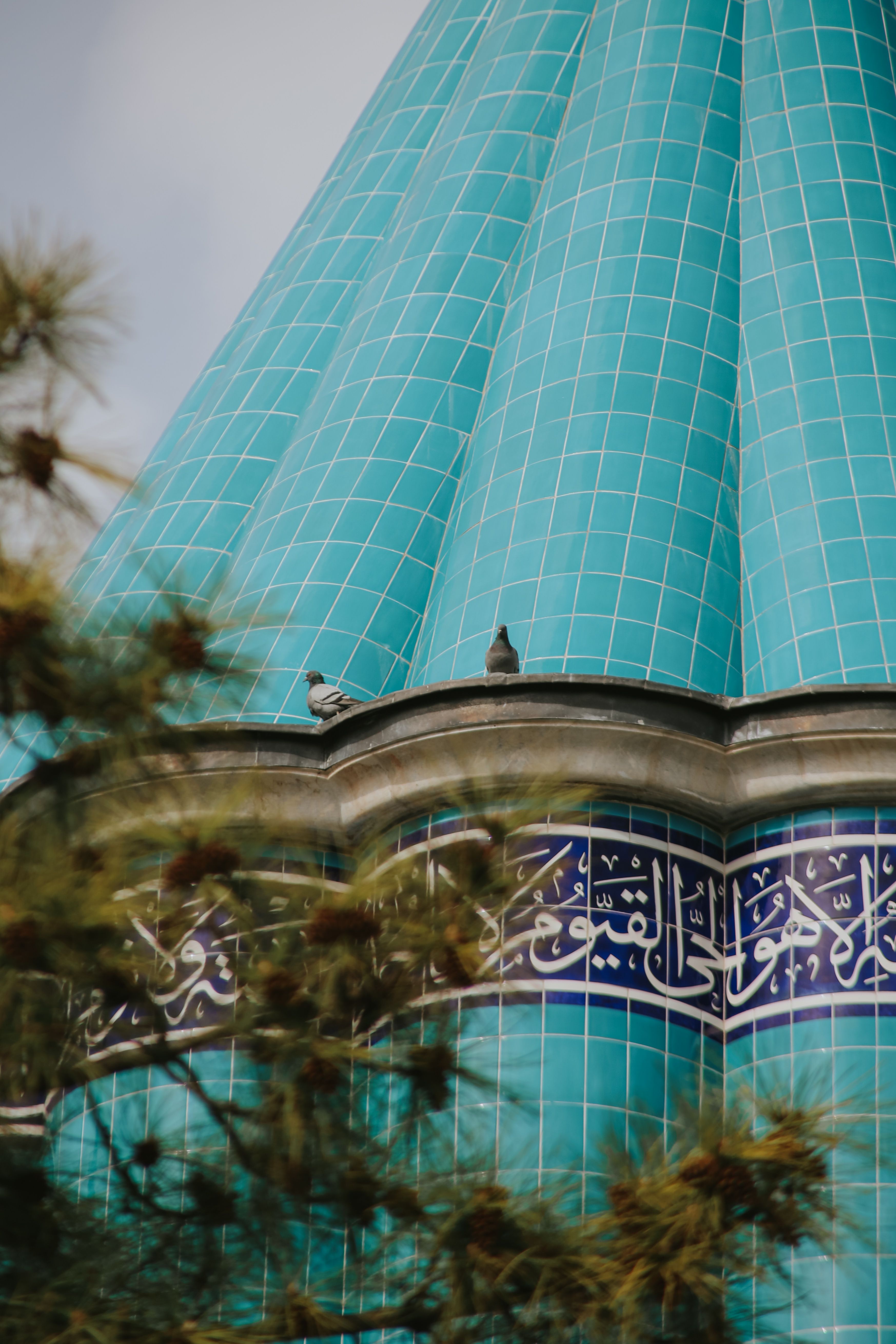Turquoise Dome with Arabic Calligraphy and Pigeons · Free Stock Photo