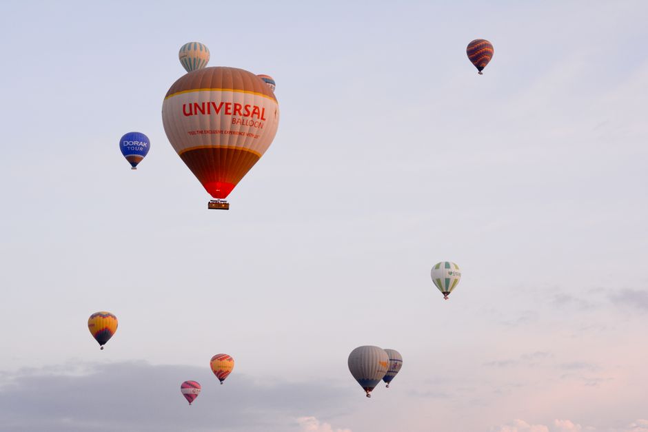 Hot air balloons floating over Vilnius Old Town at sunrise, Lithuania