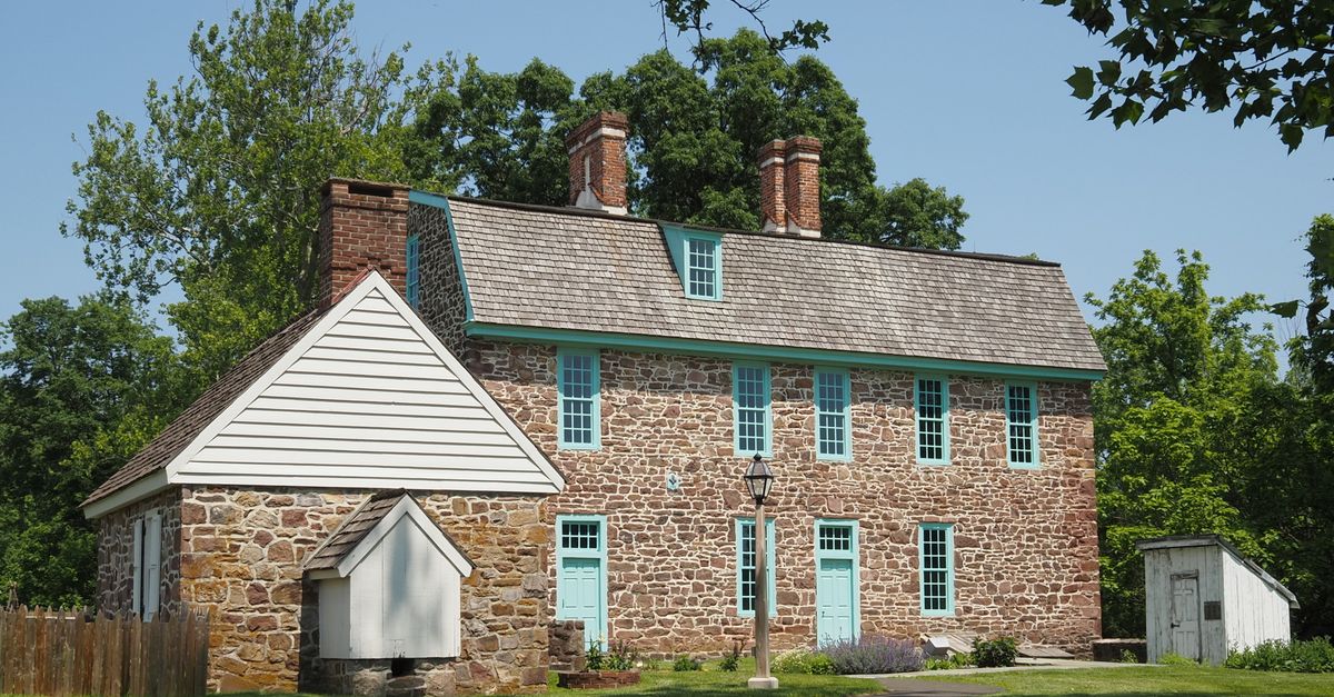 A charming historic stone house in a lush summer setting in Horsham, PA.