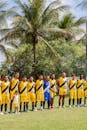 Local Soccer Team Posing Outdoors in Uniforms