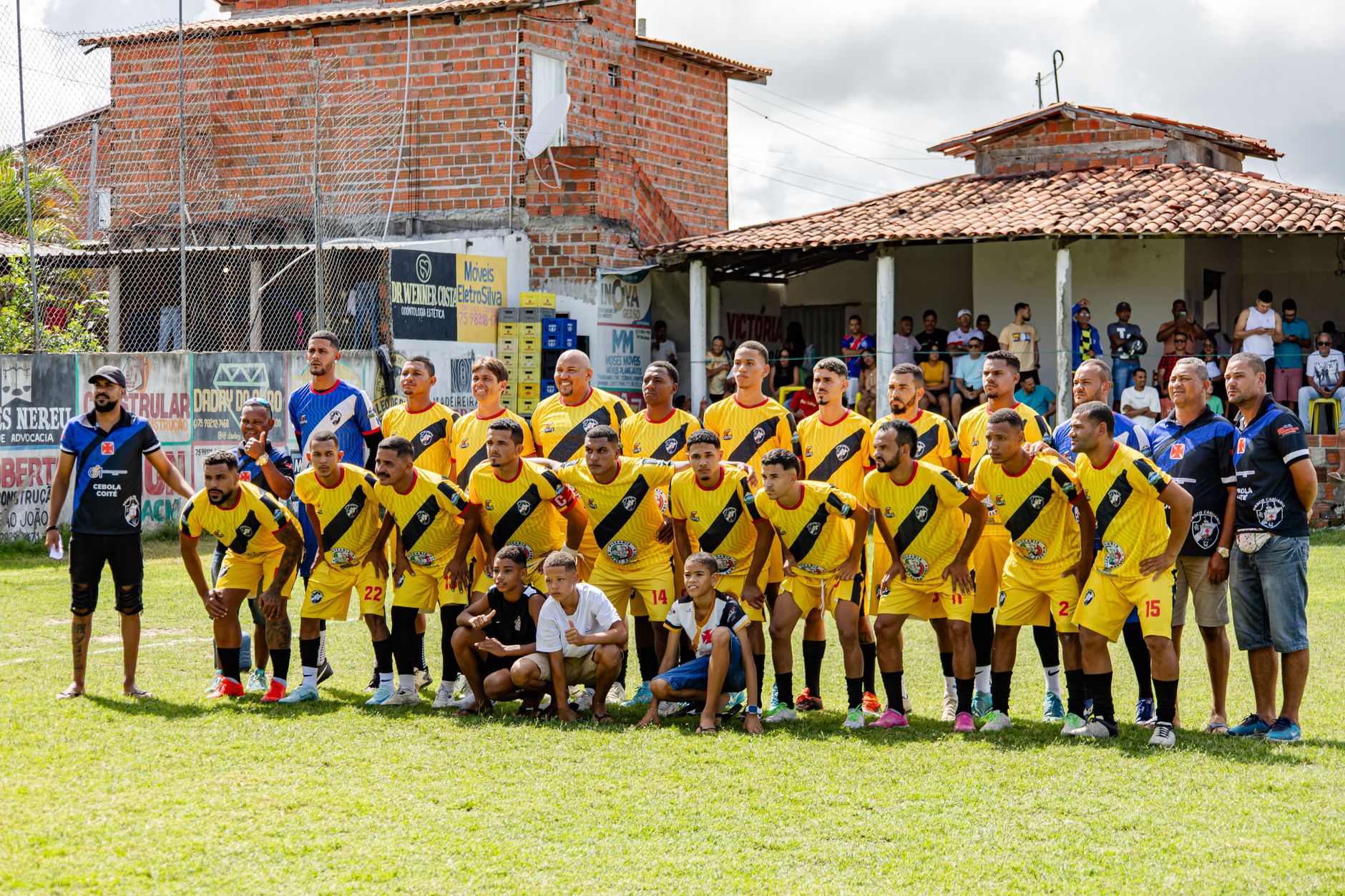 Local amateur football team poses for a group photo before starting their match.