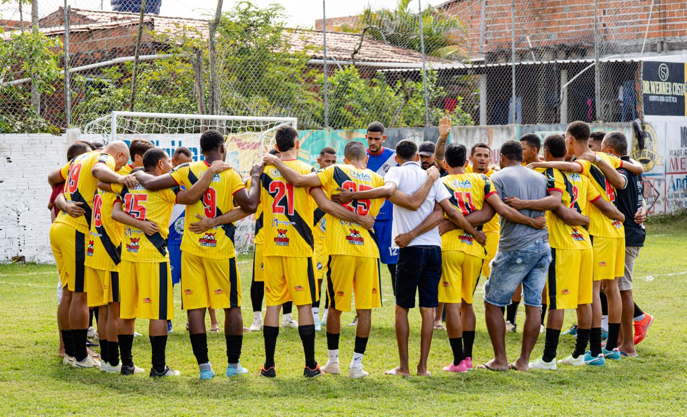 A football squad huddled in coordinated Meridian teamwear