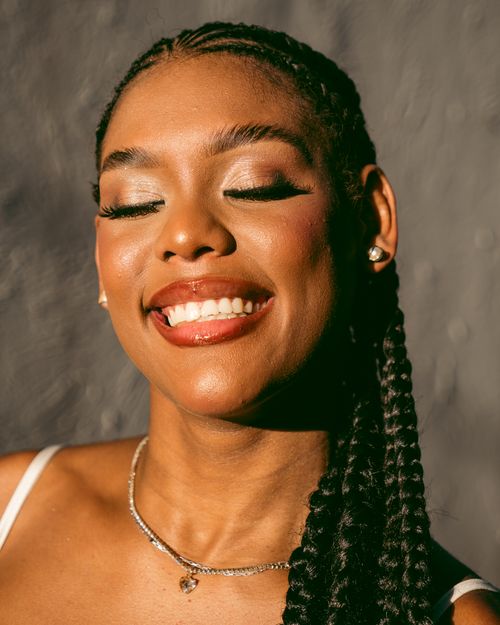 Free Close-up portrait of a smiling woman with closed eyes basking in sunlight. Stock Photo