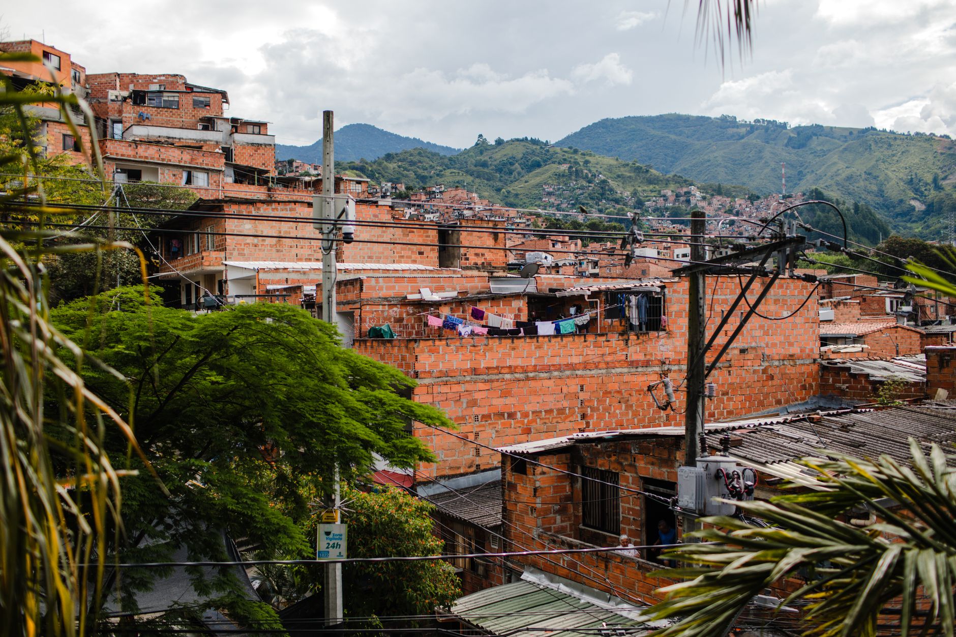 Medellín residential neighborhood mountains — Medellín Laureles vs El Poblado cost comparison for Colombia expat budget 2026
