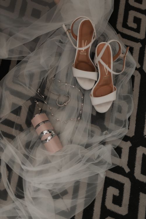 Free Flat lay of elegant bridal shoes and accessories on decorative fabric. Stock Photo