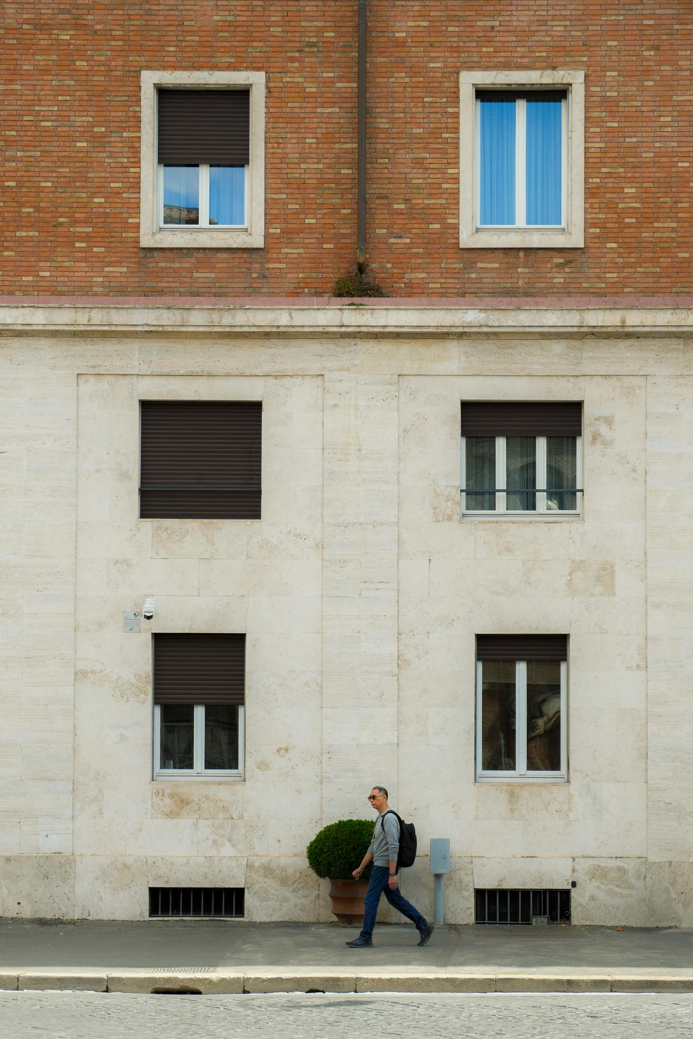 urban scene with pedestrian walking by building
