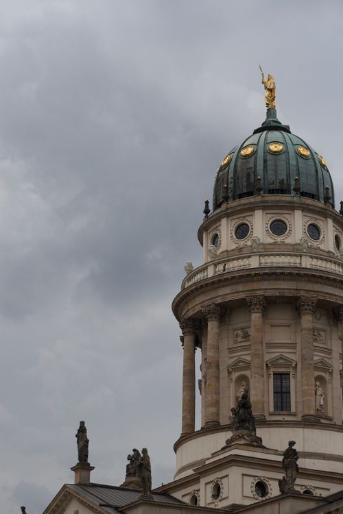 Free The iconic dome of Gendarmenmarkt, a historic landmark in Berlin, Germany, under a cloudy, moody sky. Stock Photo