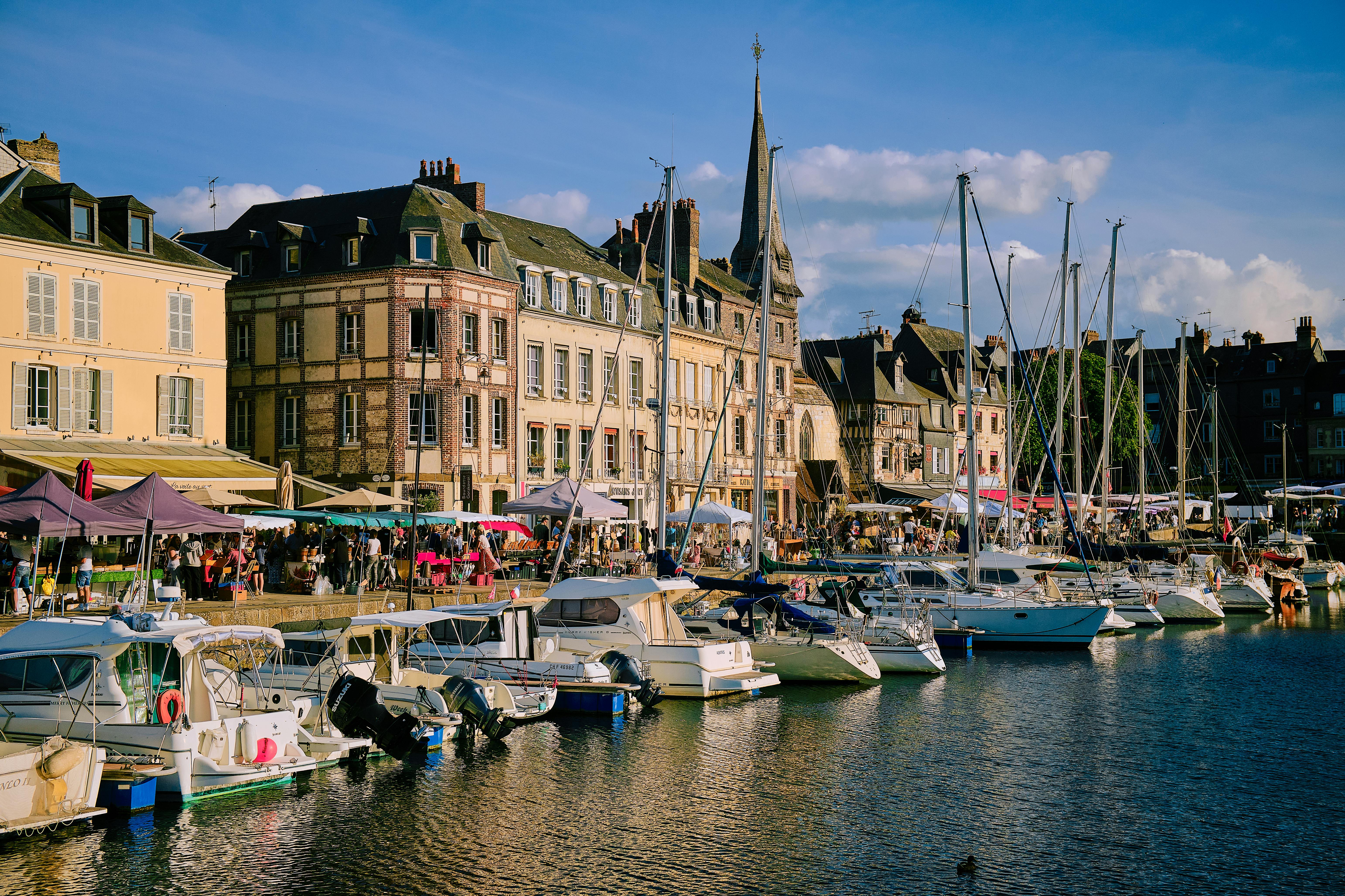 A picturesque view of Honfleur Marina in Normandy, France with boats and historic architecture.