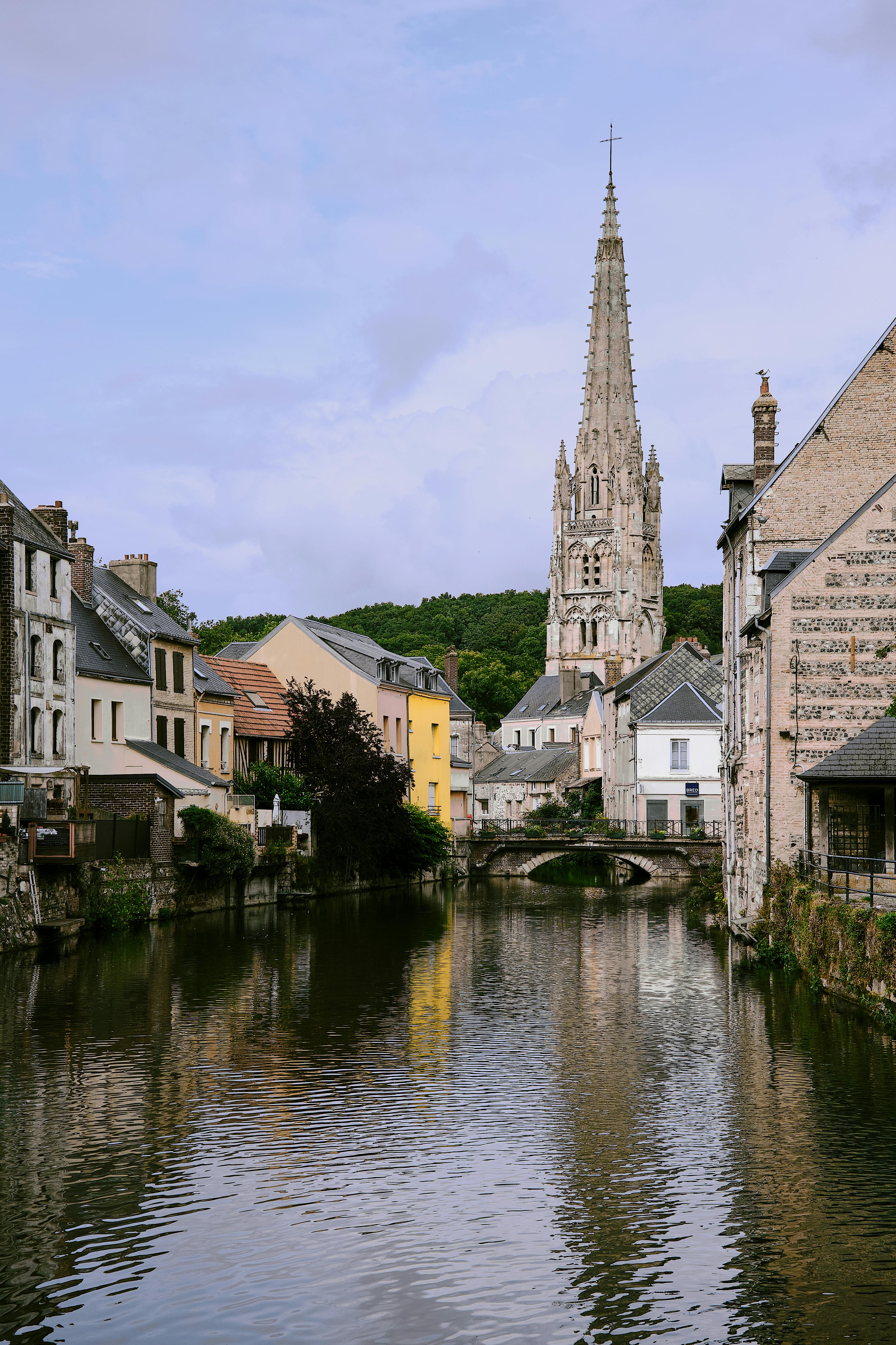 Picturesque canal scene with historic architecture in Harfleur, Normandy.