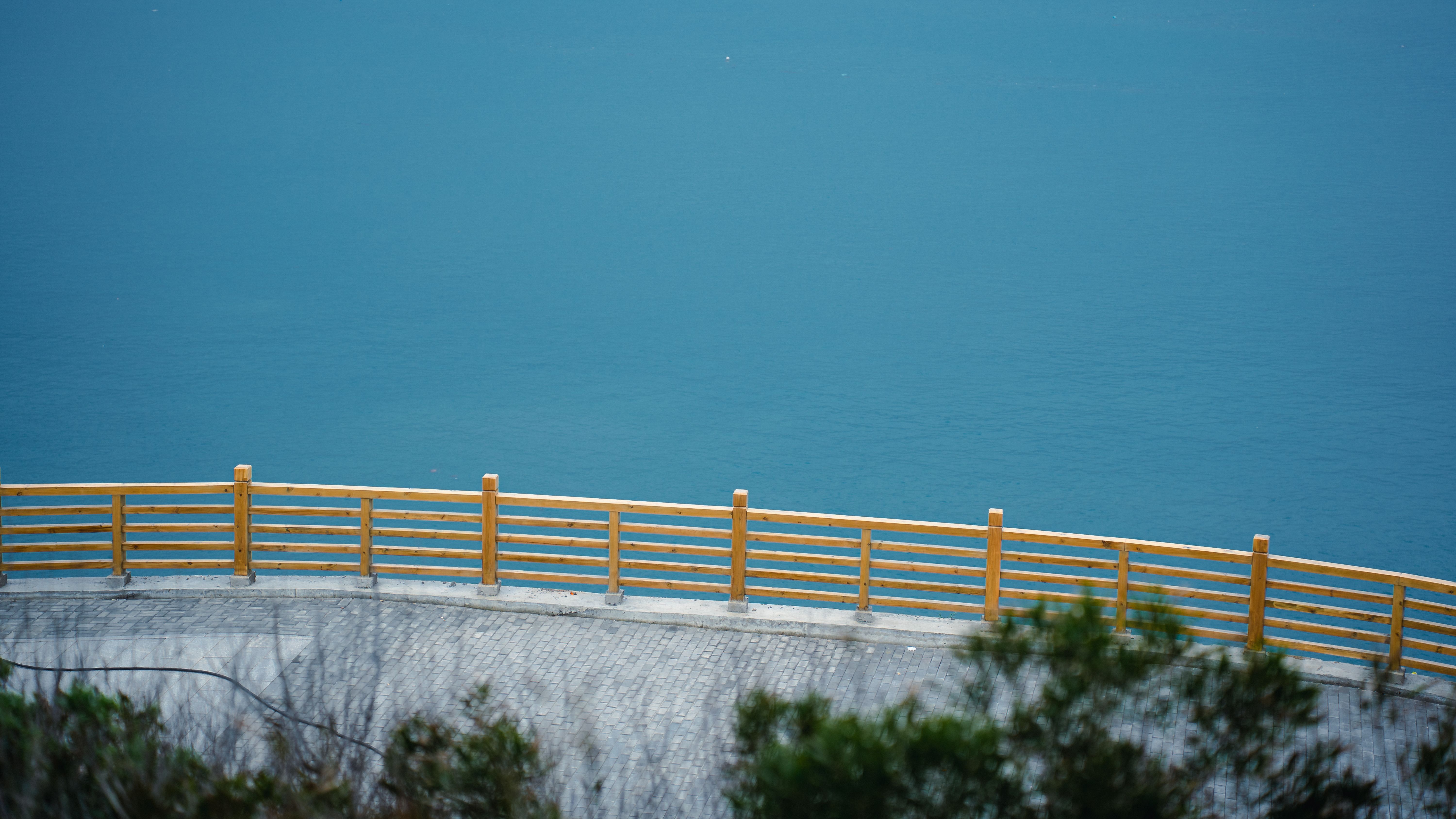 Scenic Ocean View with Wooden Railing · Free Stock Photo