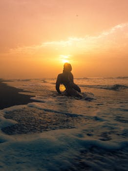 Person enjoying a serene sunset on a Lagos beach. Perfect for travel and relaxation themes.