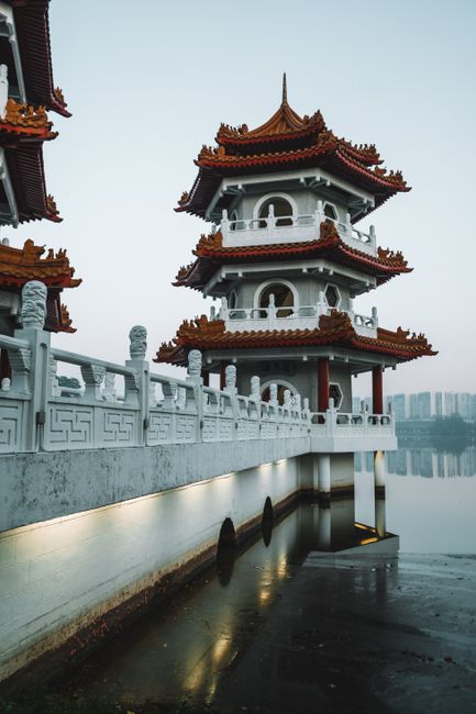 A stunning pagoda reflecting over a serene lake in a tranquil setting, capturing the essence of traditional architecture.