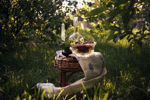 Charming outdoor picnic setting with a wicker table and decorative items.