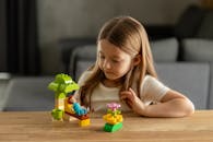 Young Girl Playing with Colorful Toy Set Indoors