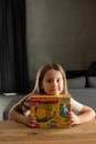 Young Girl Holding a Boxed Toy Constructor