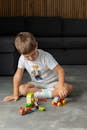 Young Boy Playing with Toy Building Blocks Indoors