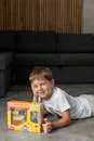 Smiling Boy Posing with Toy Construction Set at Home