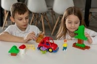 Children Playing with Colorful Building Blocks
