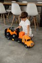 Child Playing with Toy Truck Indoors