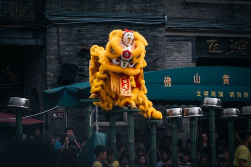 Free A colorful and dynamic yellow lion dance performed outdoors capturing cultural vibrancy. Stock Photo