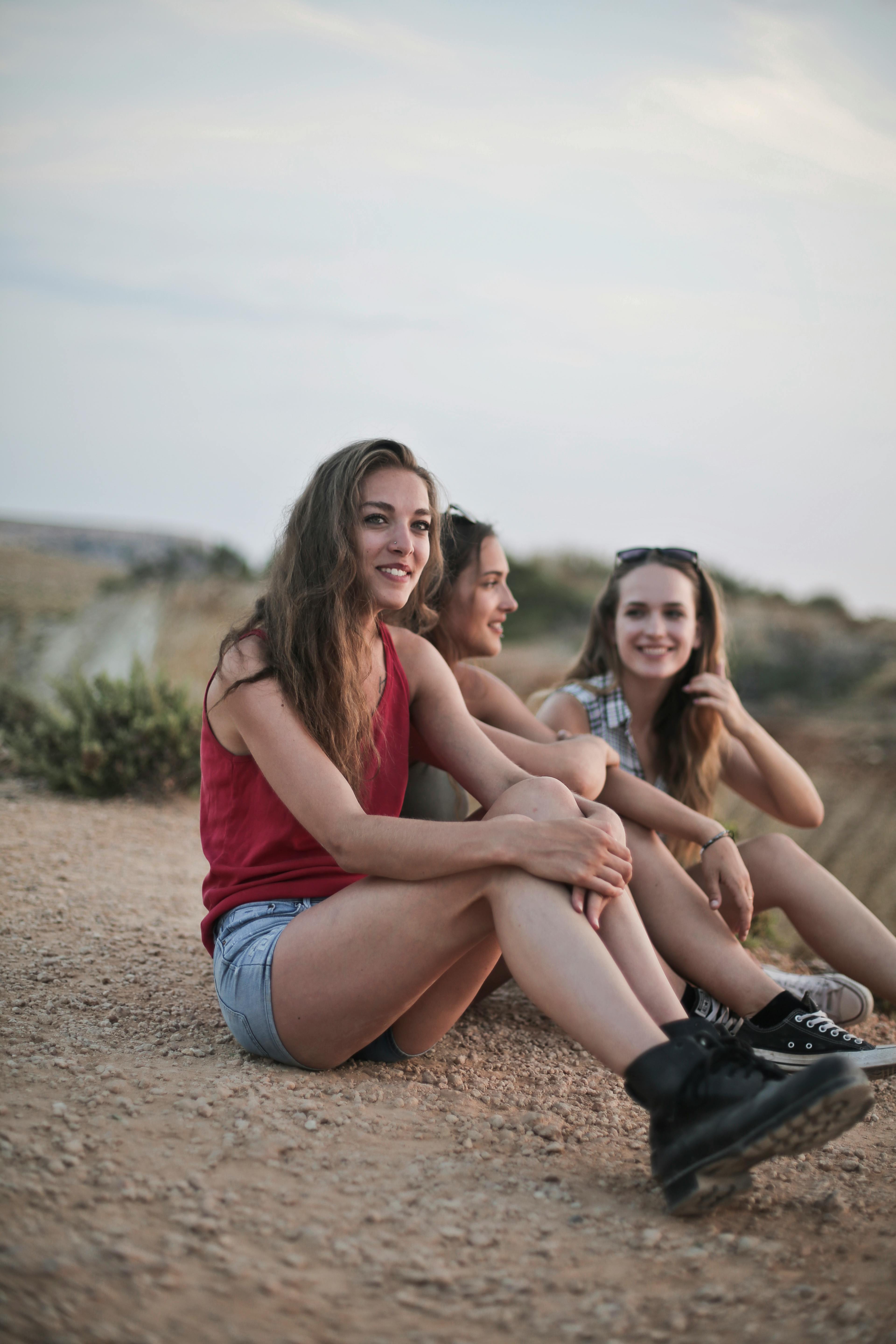 photo of women sitting on ground