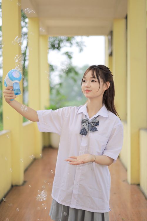 Young Girl Playing With Bubbles In School Uniform Free Stock Photo young-girl-playing-with-bubbles-in-school-uniform-free-stock-photo