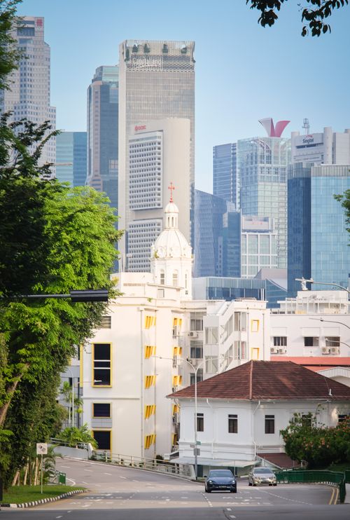 Free View of a historic church amidst modern skyscrapers in Singapore city skyline. Stock Photo