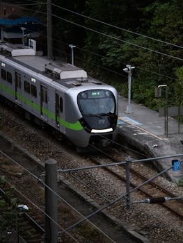 Stylish modern train on rail tracks in Taiwan. Captured in spring, showcasing rail infrastructure.