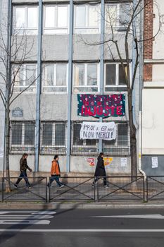 Street scene with protest signs and pedestrians in Paris, France, showcasing activism.