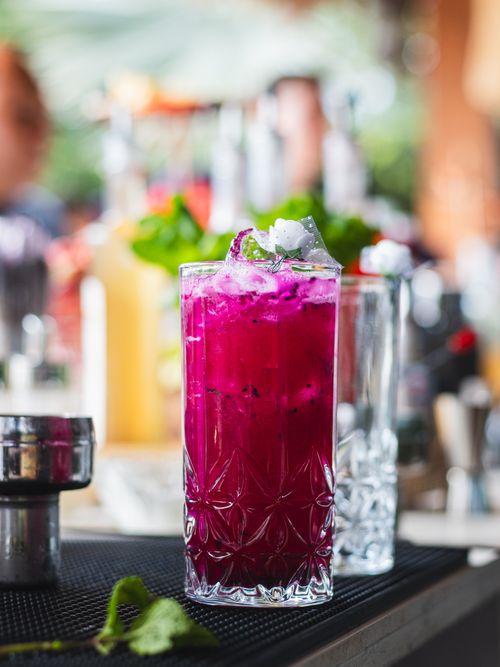 Free Vibrant dragon fruit cocktail with ice, set outdoors in sunny Brazil's summer ambiance. Stock Photo