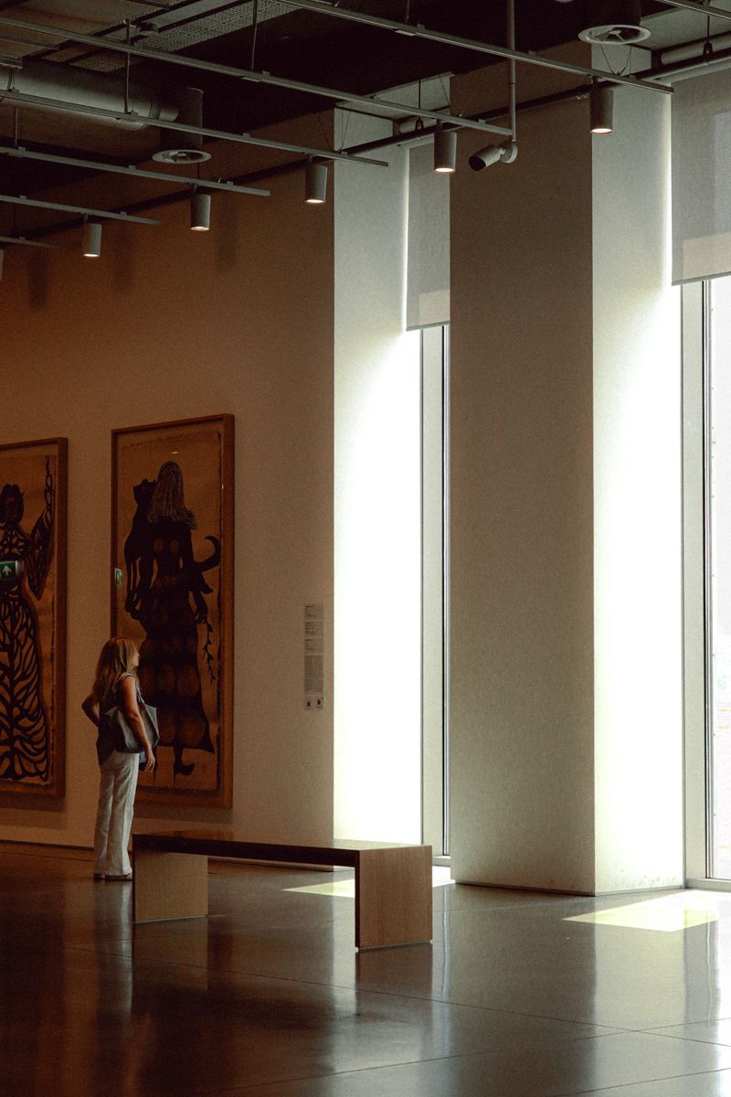 Sunlit corner of a modern gallery with sculptures